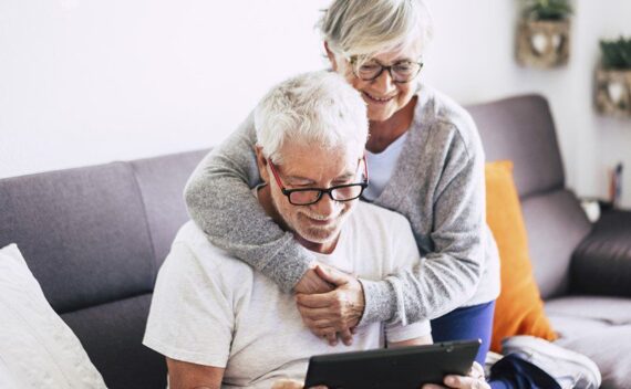 Senior couple on computer looking at two homes