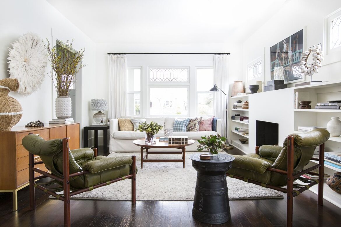 Open livingroom with white walls and large windows.