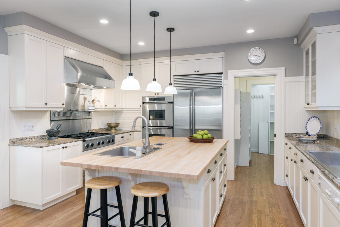 Beautiful white kitchen cabinetry which goes to the ceiling. Kitchen has marble countertops with stainless steel appliances.