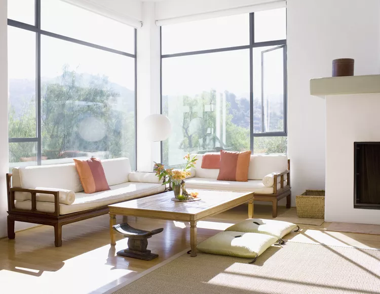 living room with large windows allowing the natural light to come in.